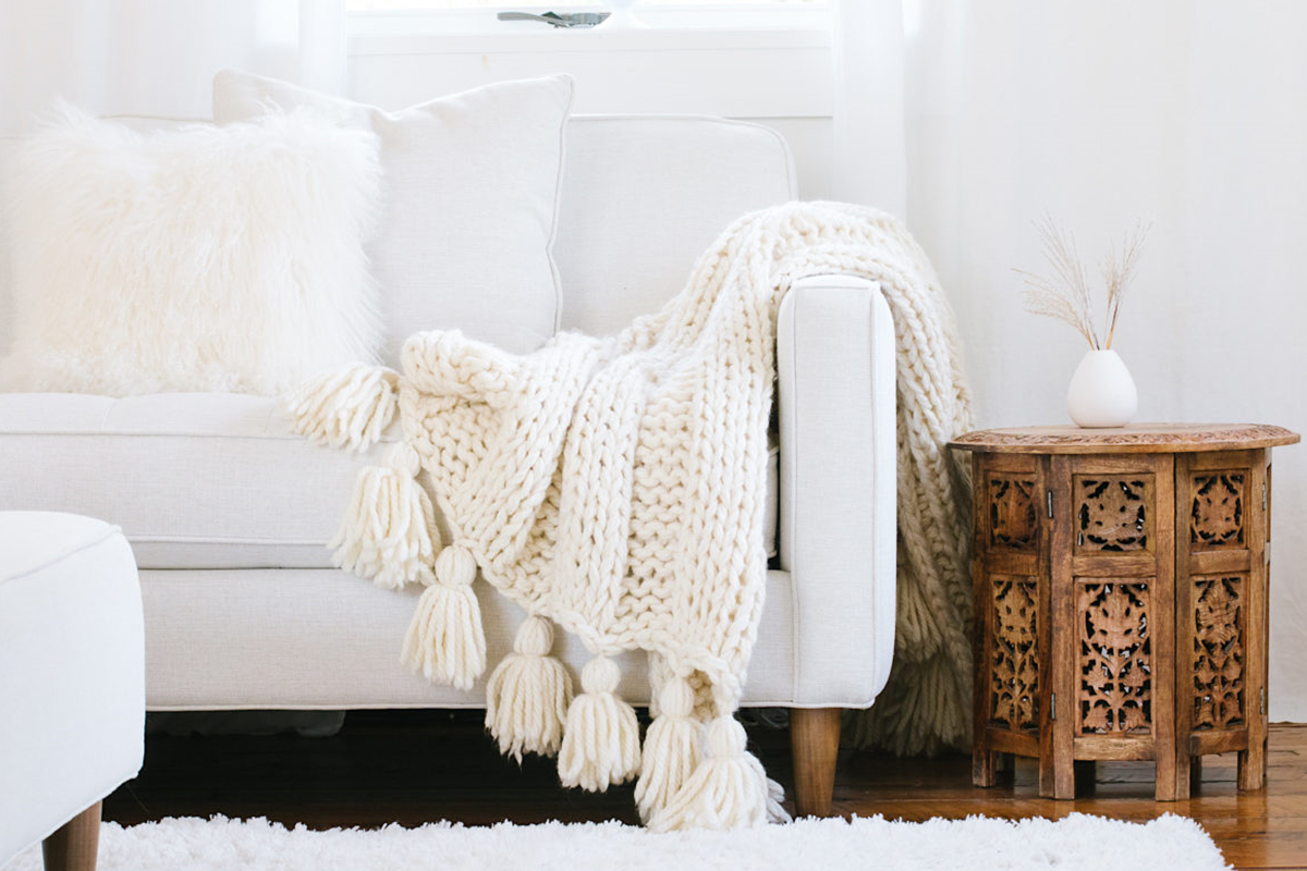 Try The Mega Luxe Cable Knit Throw With Pom Poms